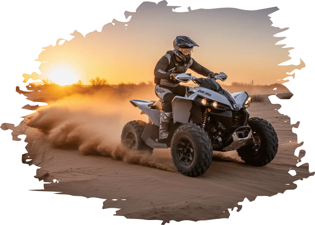 ATV rider on a rental ATV kicking up sand at sunset near Glamis