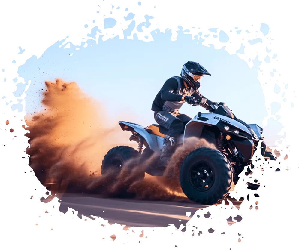ATV rider carving through sand on a rental ATV at sunset