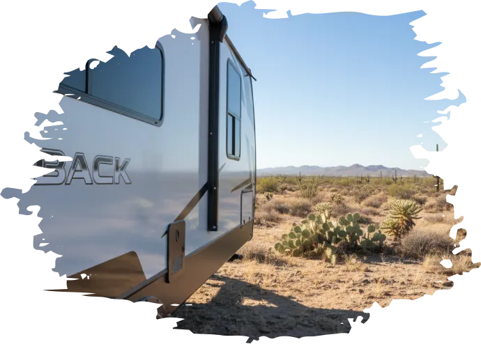 Travel trailer RV rental parked beside desert cactus near the Glamis Sand Dunes