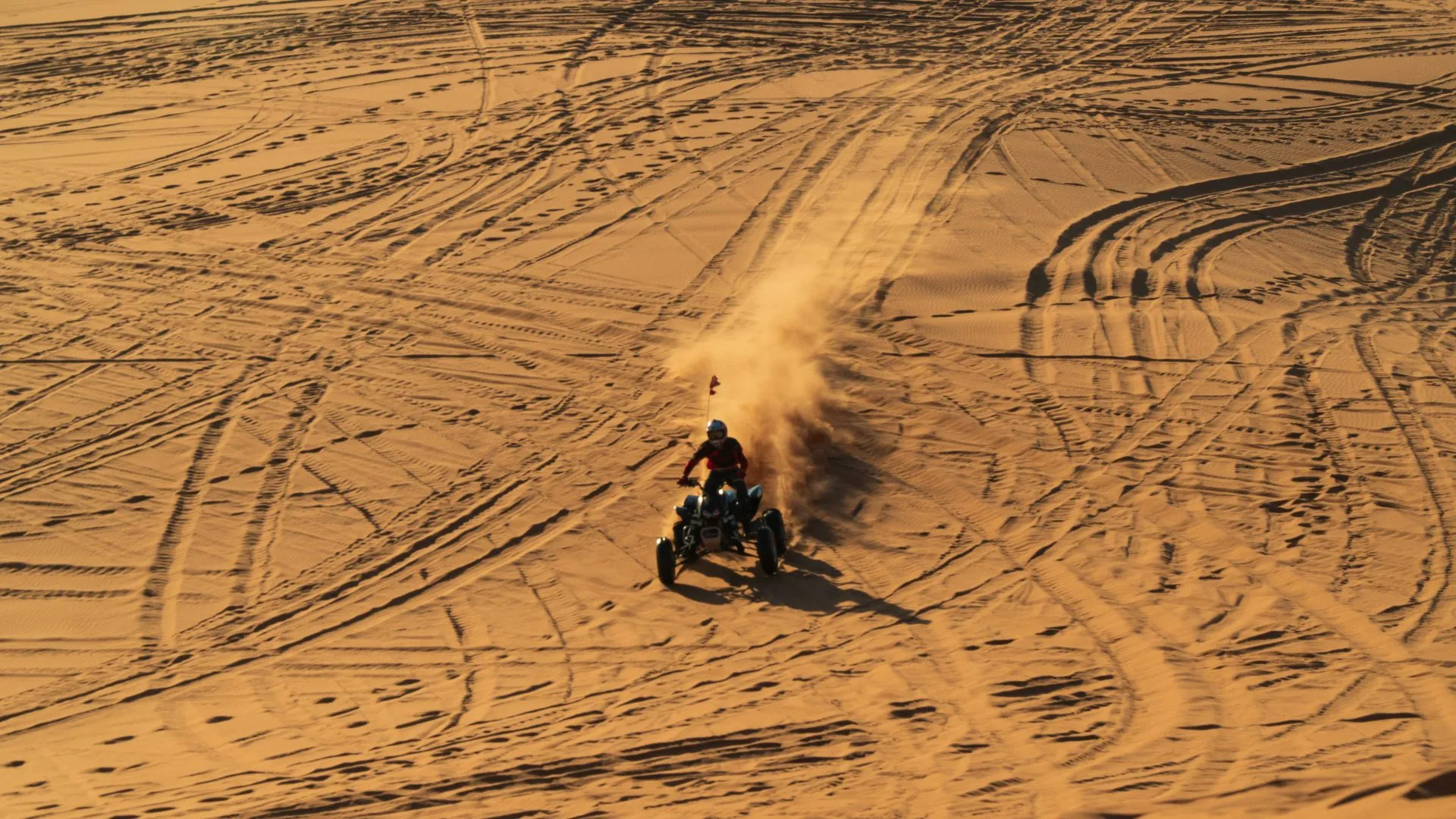 Glamis man riding motorcycle on snow covered field during daytime 